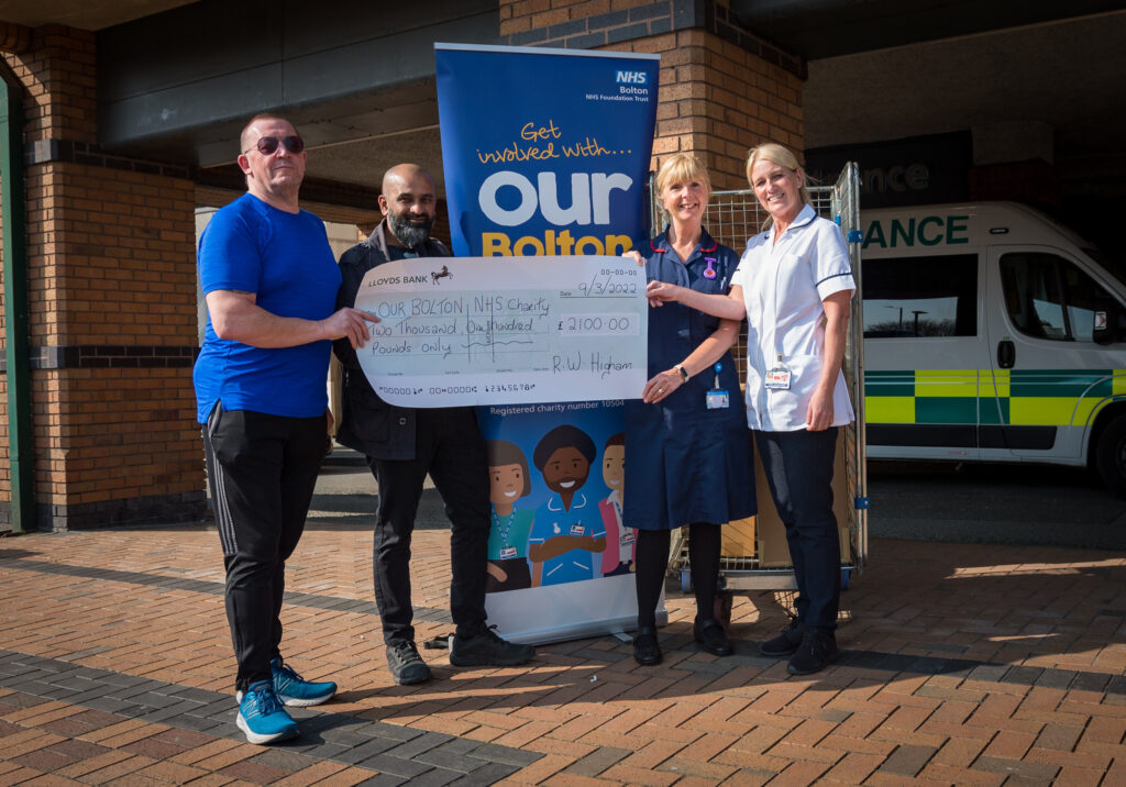 Bob Higham presenting Abdul Goni, Joanne Varker and Kate Green with a cheque