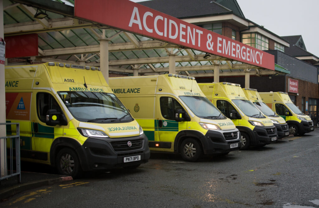 Five North West Ambulance Service ambulances wait outside Royal Bolton Hospital's emergency department