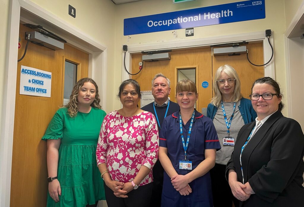 Bolton's Occupaational Health team stood outside their offices - there are five people stood there.