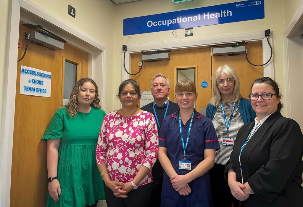 Bolton's Occupaational Health team stood outside their offices - there are five people stood there.