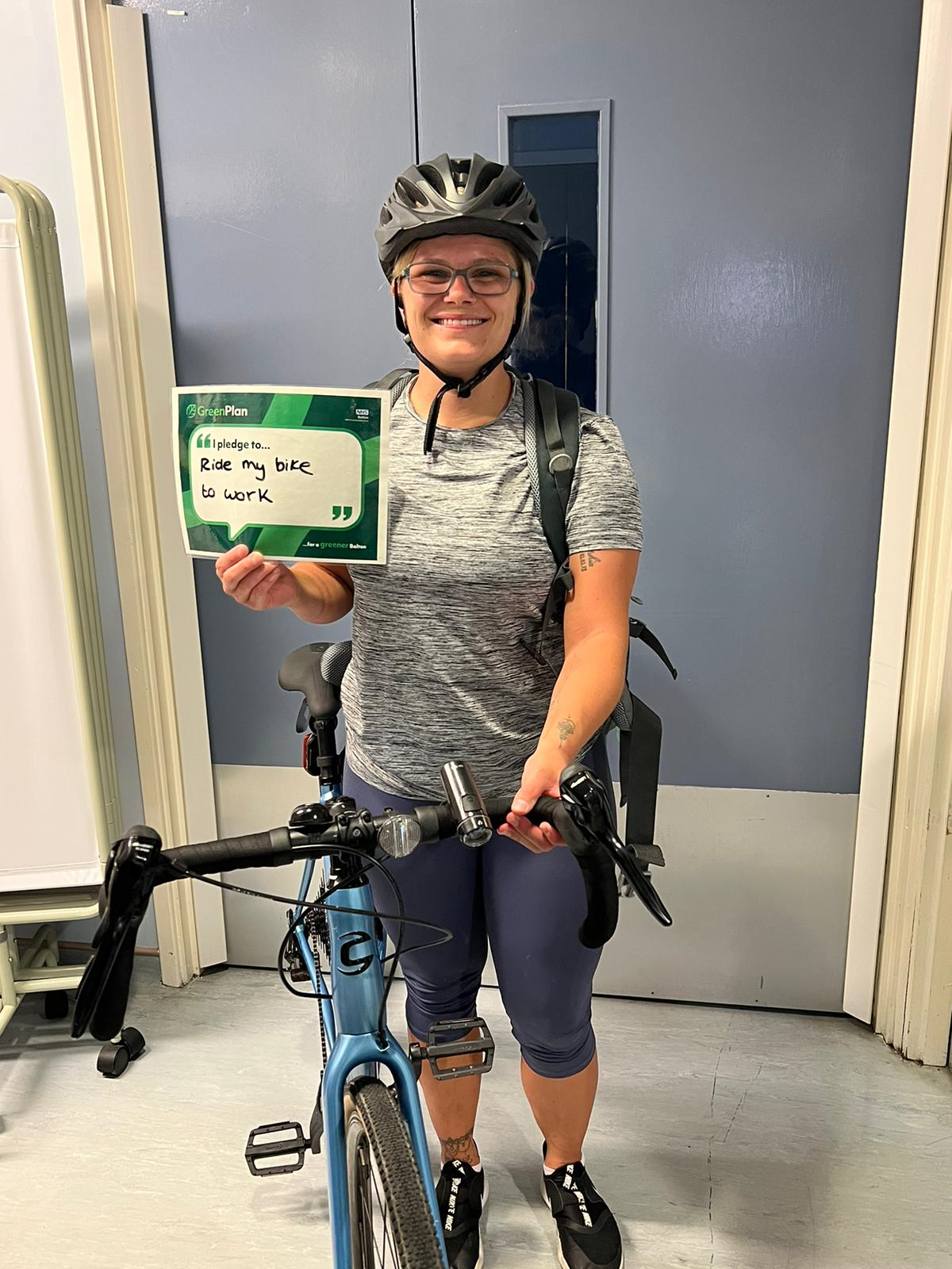 Lady in cycling gear with her bike