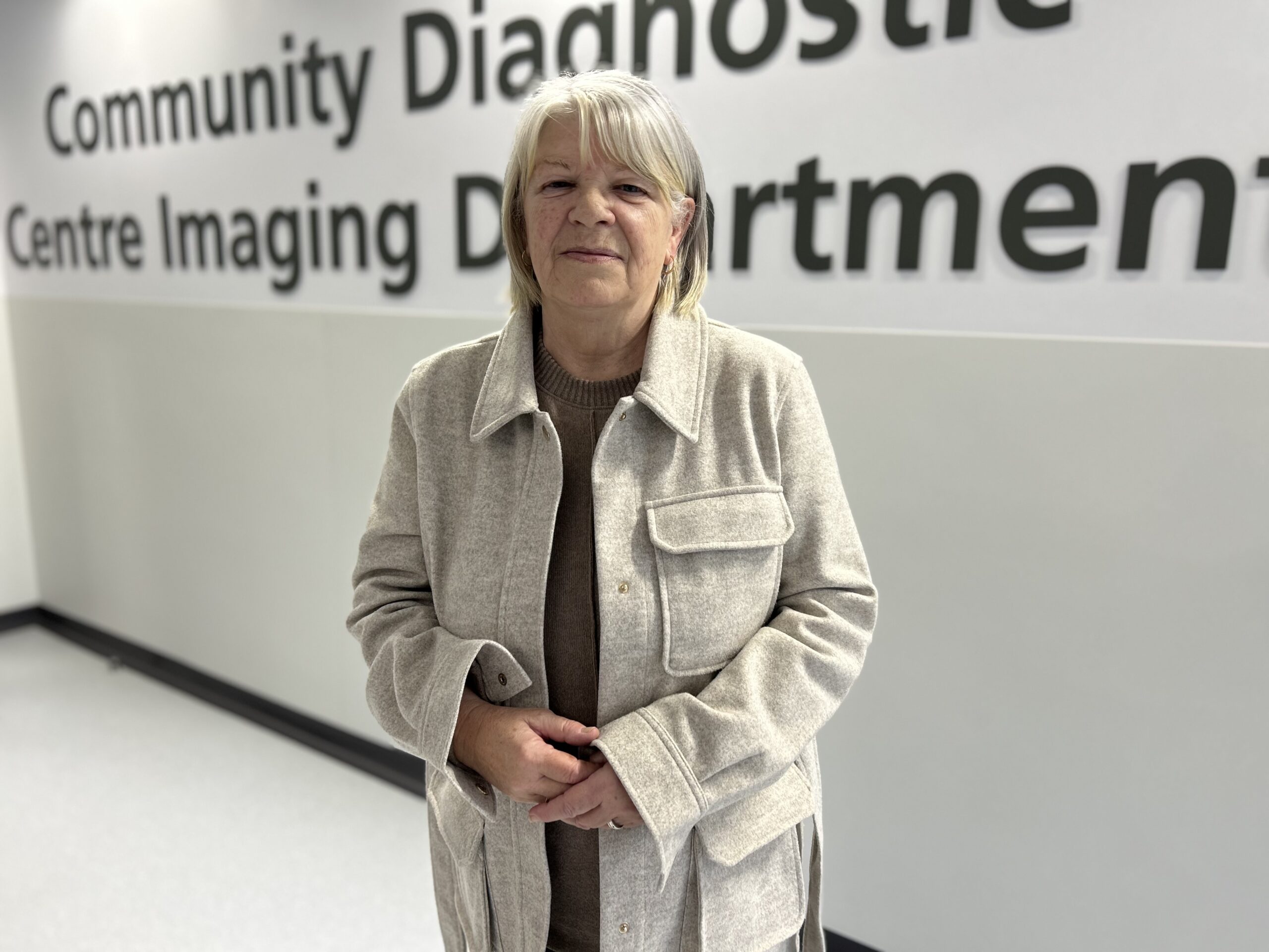 Rosemary, Bolton's first CDC patient, smiles for a picture in the entrance