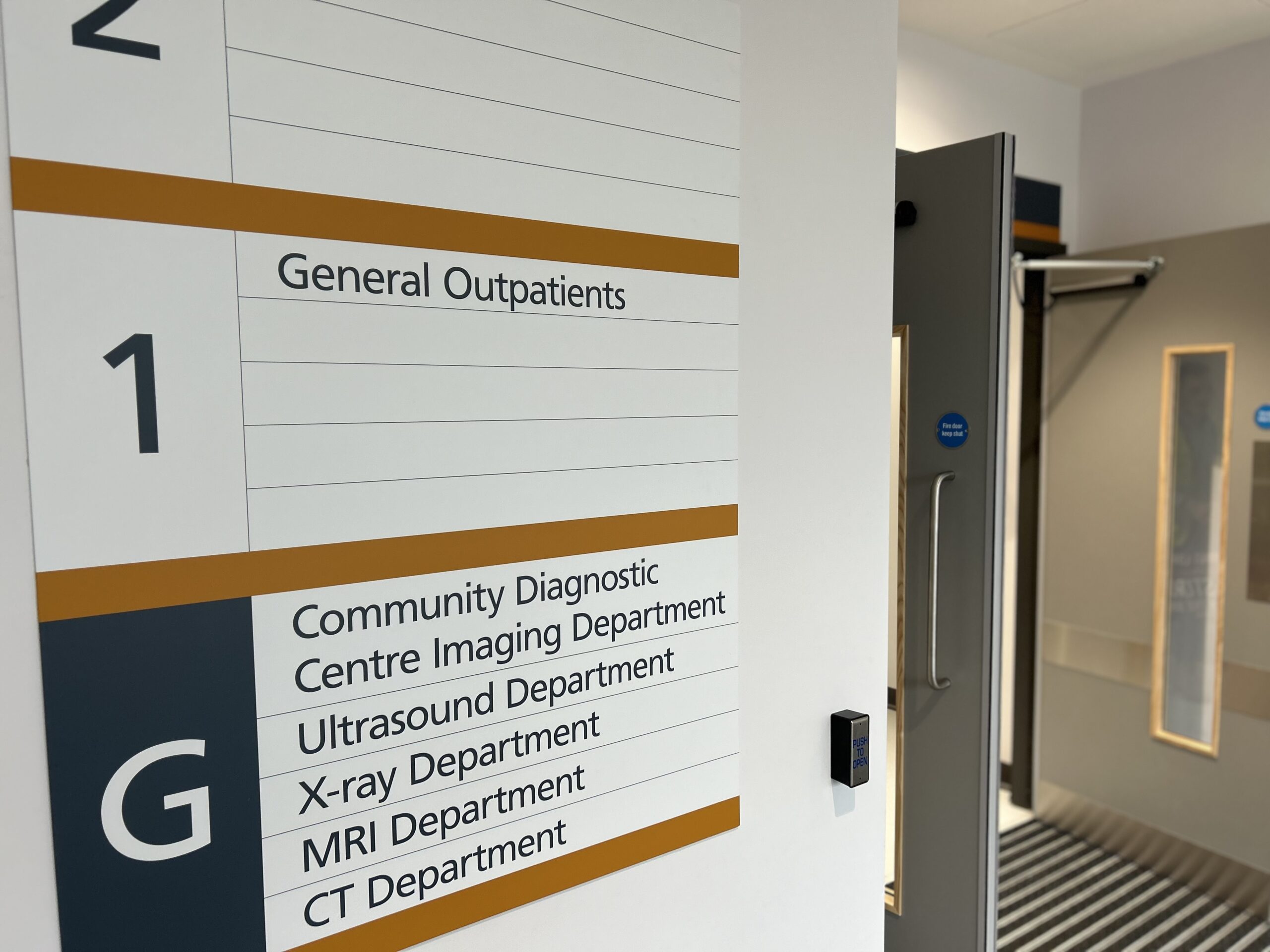 Entrance to the new CDC with a sign directing patients to the correct scan department