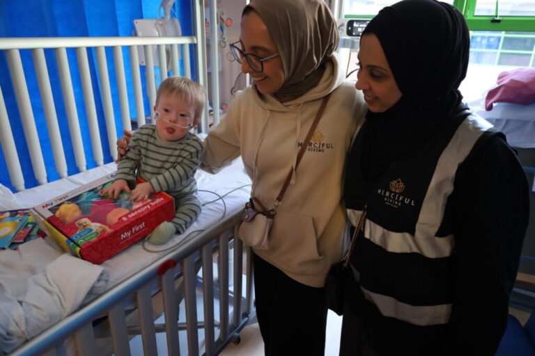 Merciful Giving with a young patient on E5 during their charity gift drop