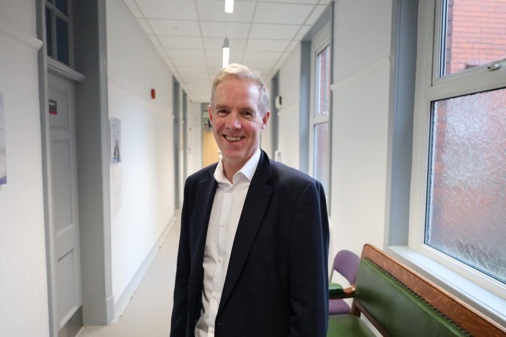Ian Williamson in Trust HQ corridor