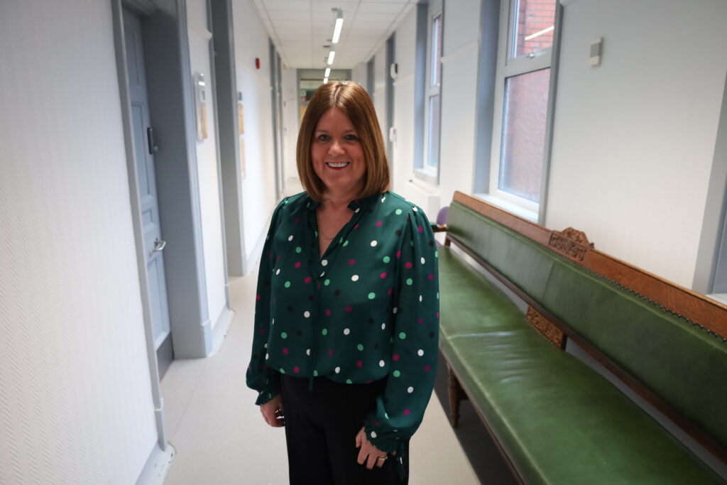 Janat Hulston smiling in Trust HQ corridor
