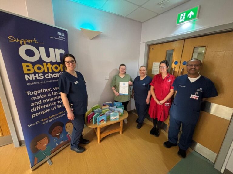 Jess Hobson poses for a picture with Neonatal Unit staff and holds her Our Bolton NHS Charity certificate