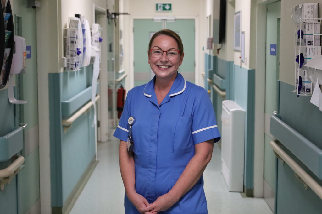 Lindsay O'Malley smiles for a picture in the corridor of Ward D3
