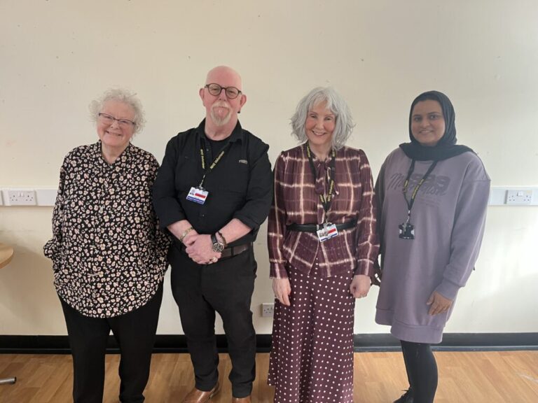 Lived Experience Group pose for a picture in front of a plain white wall