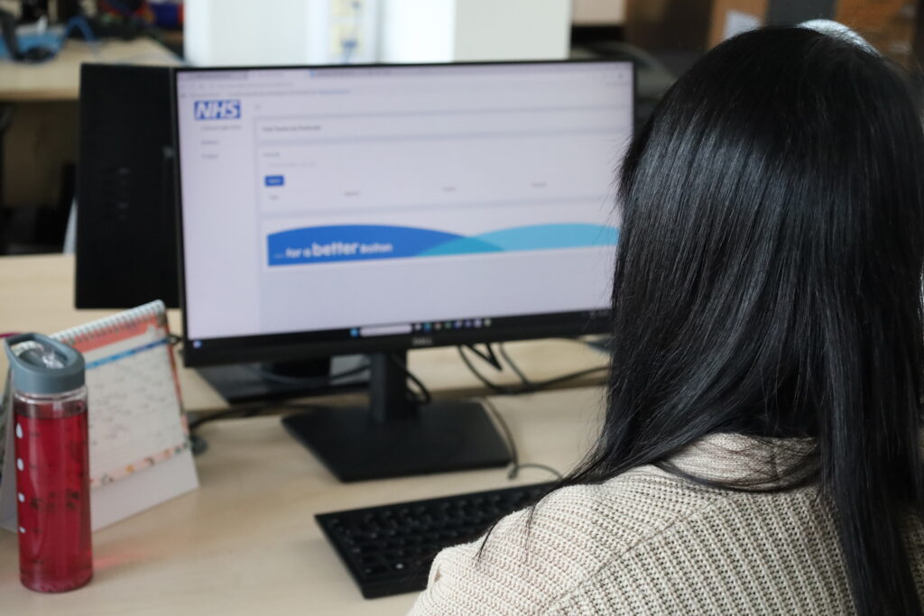 Rebecca using the postcode checker as part of her admin role