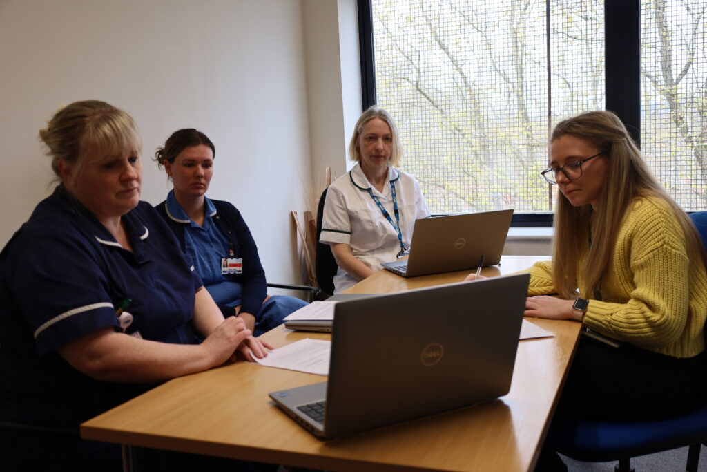 Team gather round a table for the Neighbourhood MDT Coordinator meeting