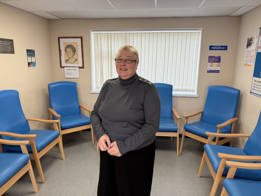Julie Killas-Riding smiles for a photo in the waiting room of Winifred Kettle Centre