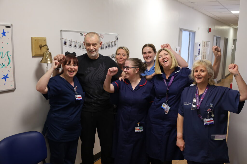 Gareth Price surrounded by the Haematology Day Unit nurses who cared for him