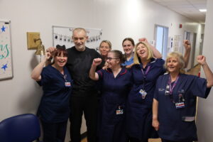 Gareth Price surrounded by the Haematology Day Unit nurses who cared for him