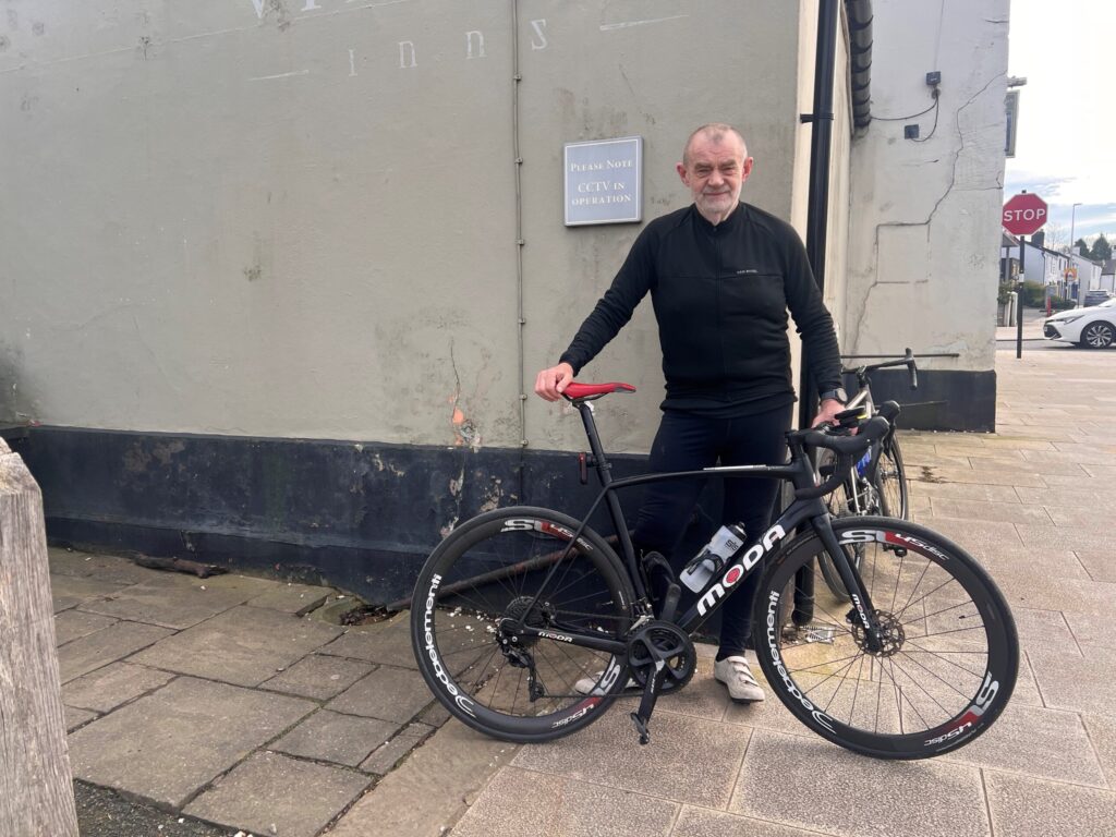 Gareth Price smiles for a picture with his bike