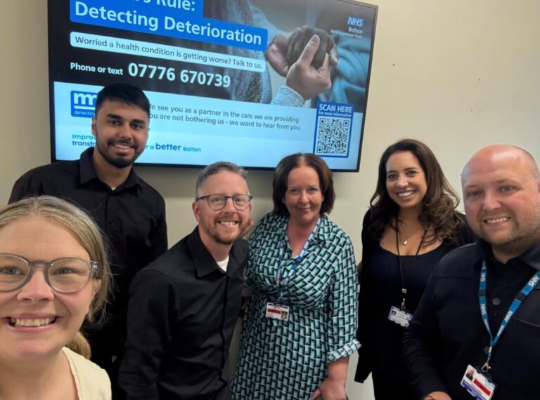 Staff from Bolton NHS FT and Bolton Deaf Society smile for a picture to mark launch of Martha's Rule