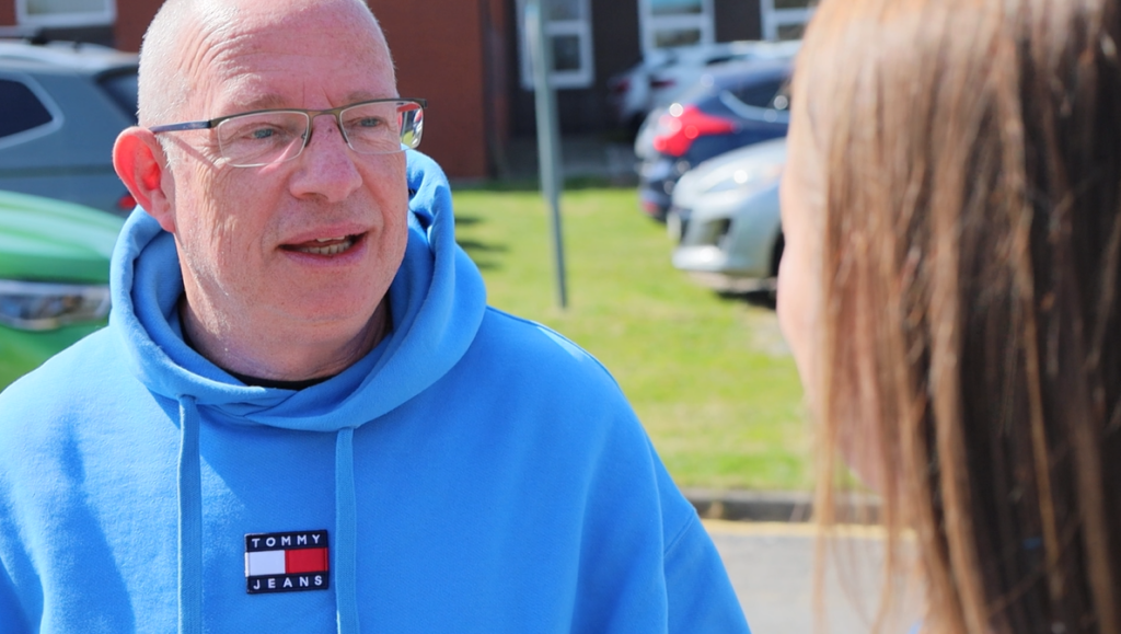 Dave Bagley chats to a member of staff in his role as governor