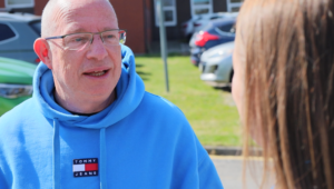 Dave Bagley chats to a member of staff in his role as governor