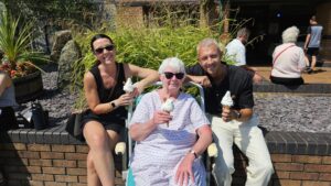 Staff and patients smile for a photo holding their free ice cream