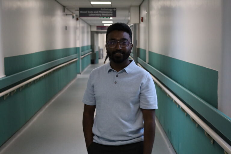 Joice Joy standing in a corridor at Royal Bolton Hospital